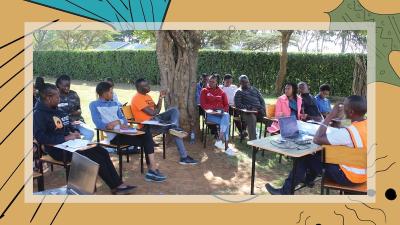 People gather at a community networking activity in Kenya. They are sitting on school chairs in an outdoor space.  image linking to Seeding change: Tanda CBO’s drive to strengthen the community network movement in Kenya